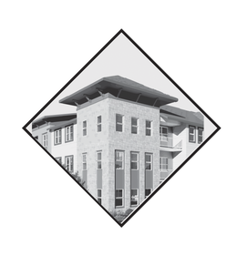 A multi-story building with stone-textured facade and a wide, overhanging roof, presented within a diamond-shaped frame.