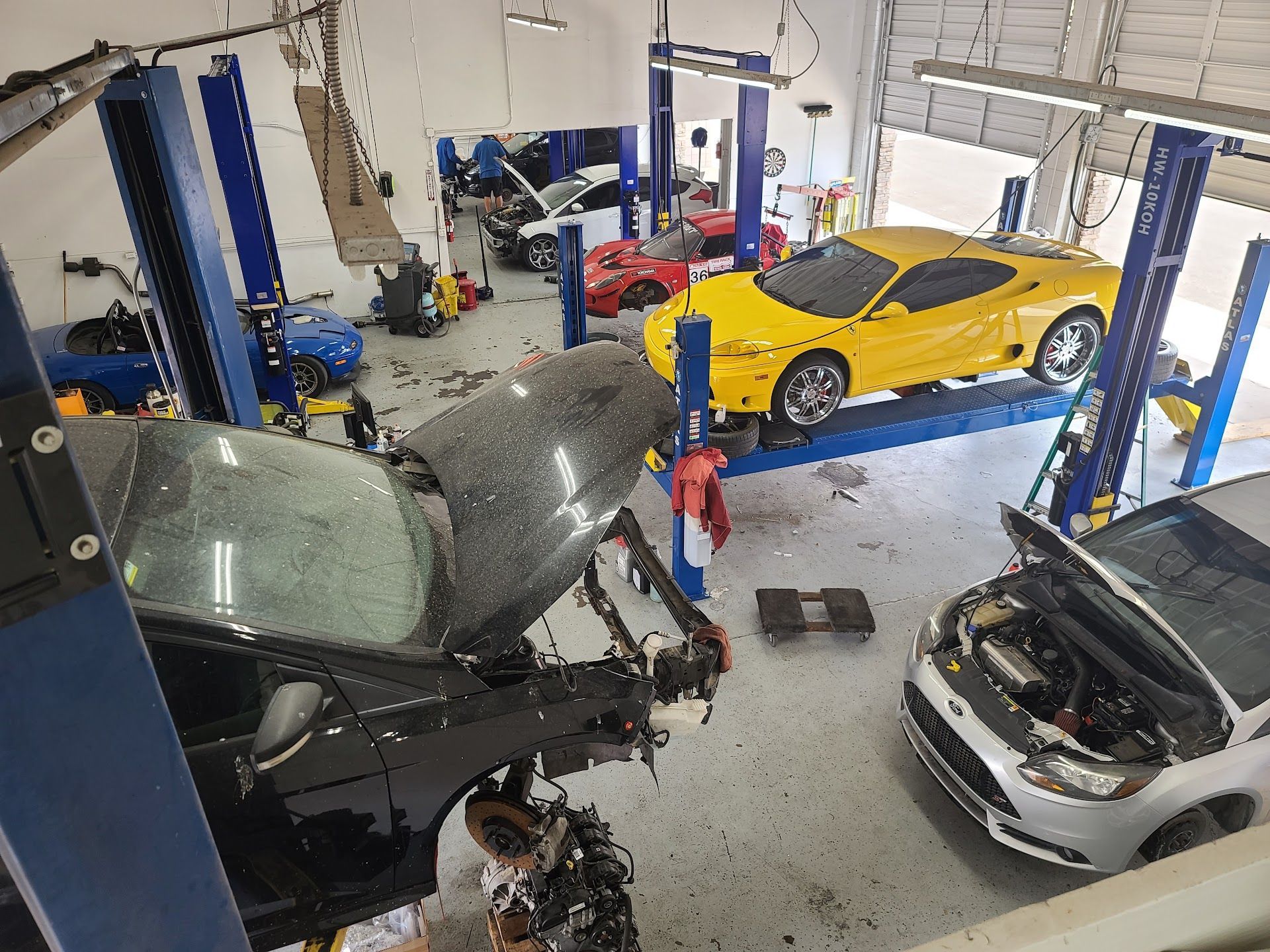 Multiple Cars Being Serviced Inside The Workshop | Elston Auto Care