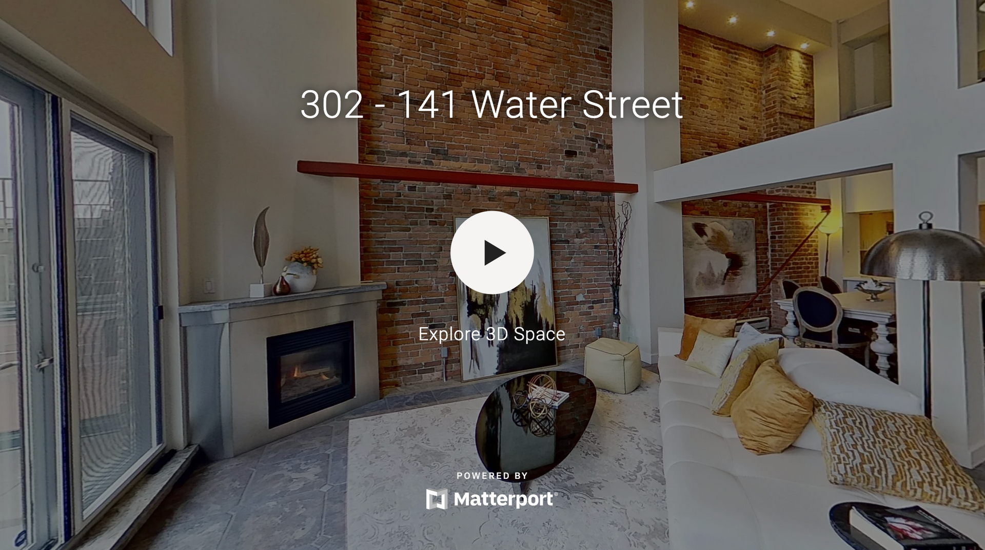 A virtual tour of a living room with a fireplace and sliding glass doors.