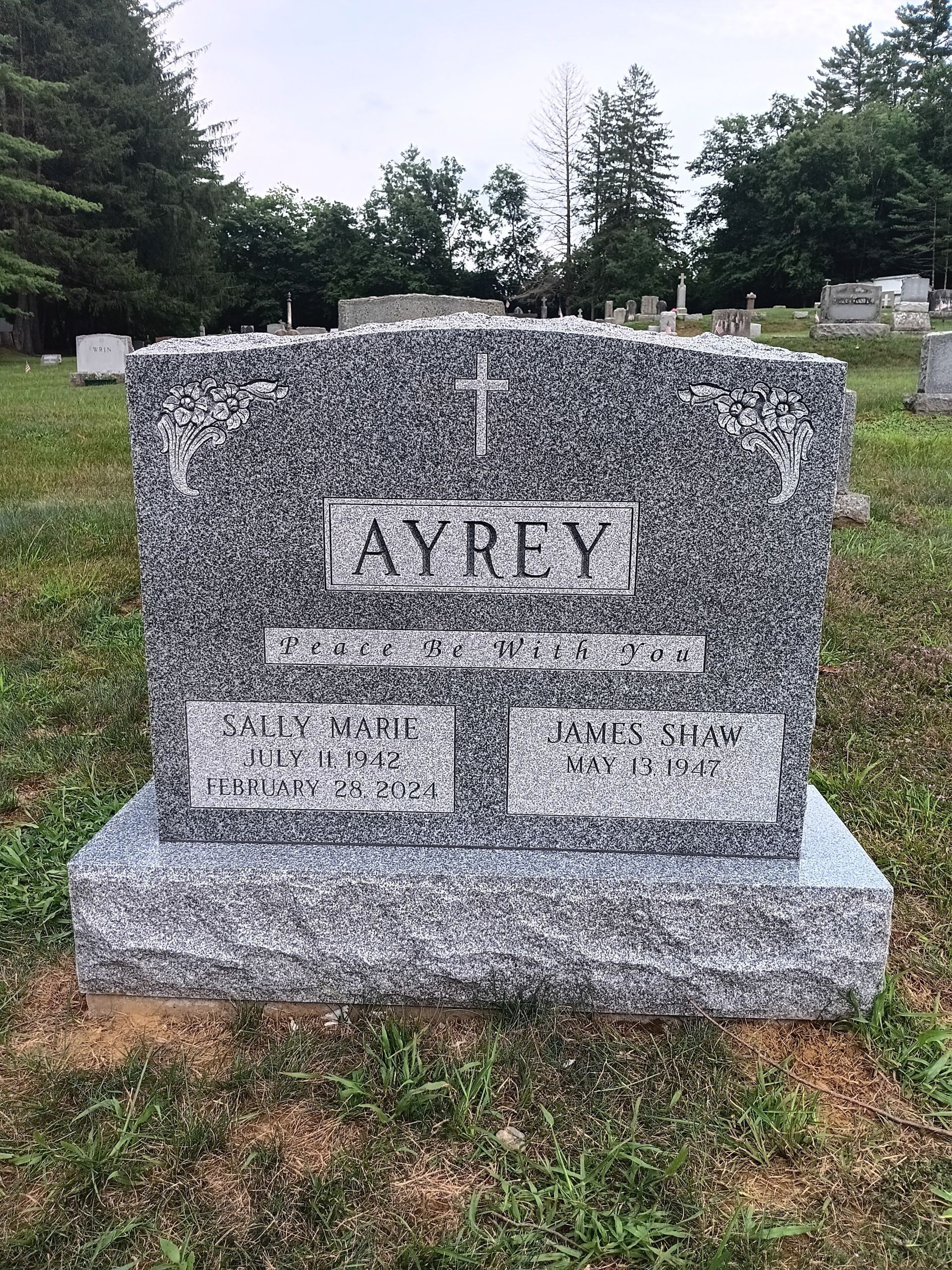 Gray granite headstone in a cemetery. 