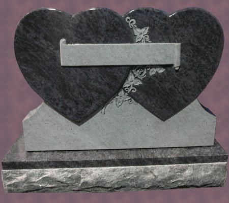 Gray double heart-shaped gravestone with engraved floral details and rectangular inscription space.