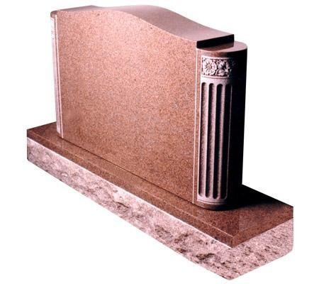 Pink granite headstone with decorative column and sculpted top, resting on a stone base.