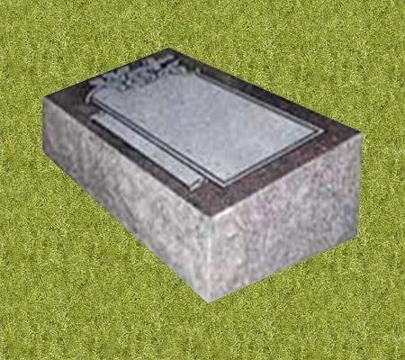 A rectangular granite headstone with a recessed plaque, on a grassy background.