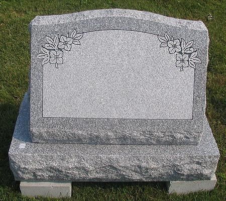 Gray granite headstone with floral etchings; blank inscription space.