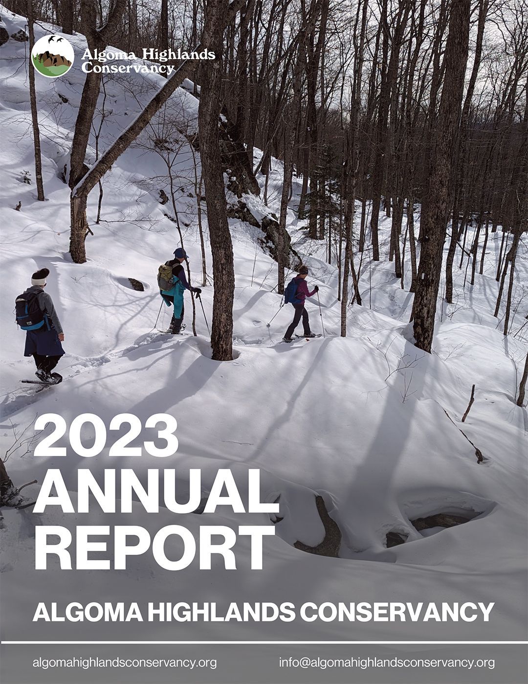 2023 Algoma Highlands Conservancy Annual Report cover: Snowshoers in snowy forest.