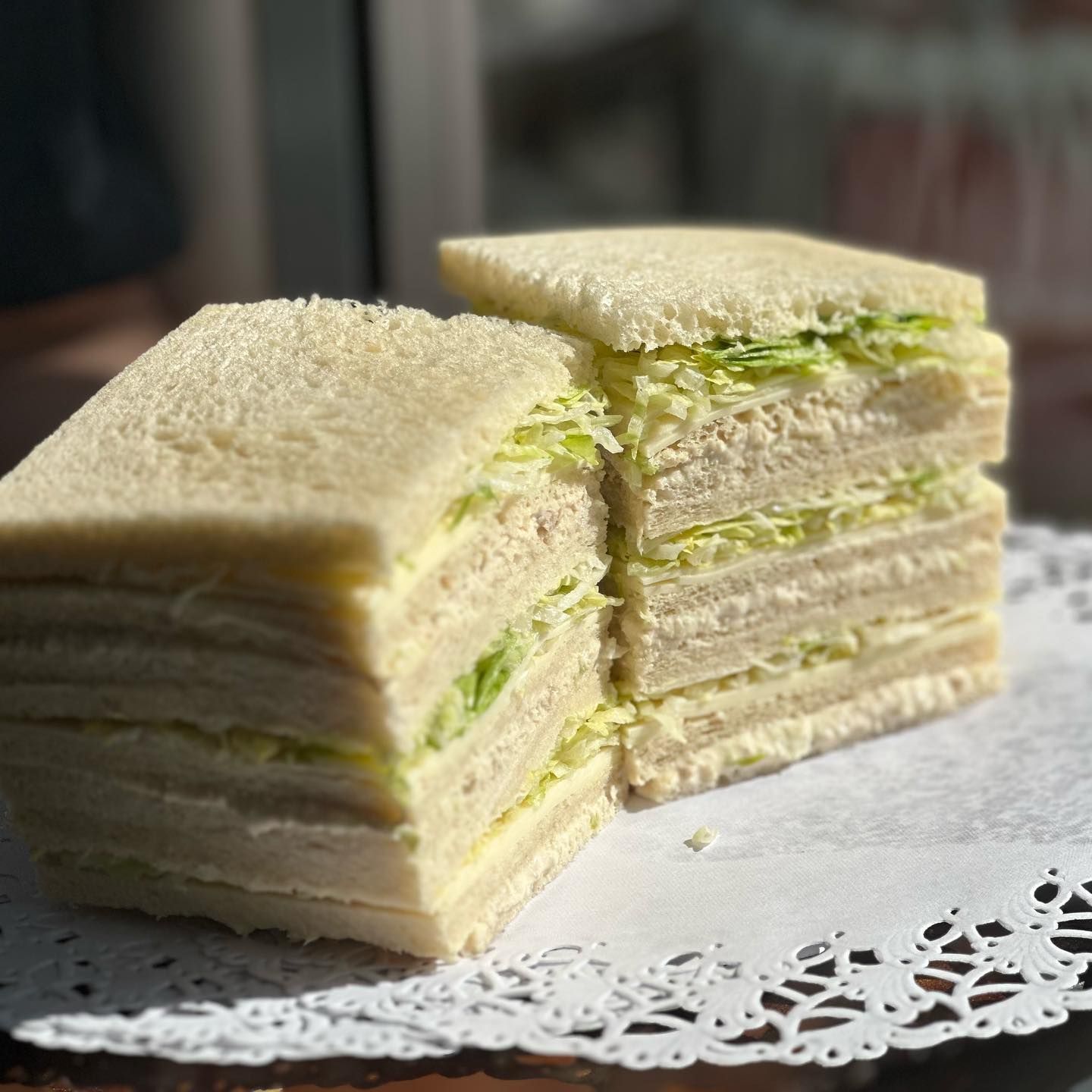 A stack of sandwiches sitting on top of each other on a table.