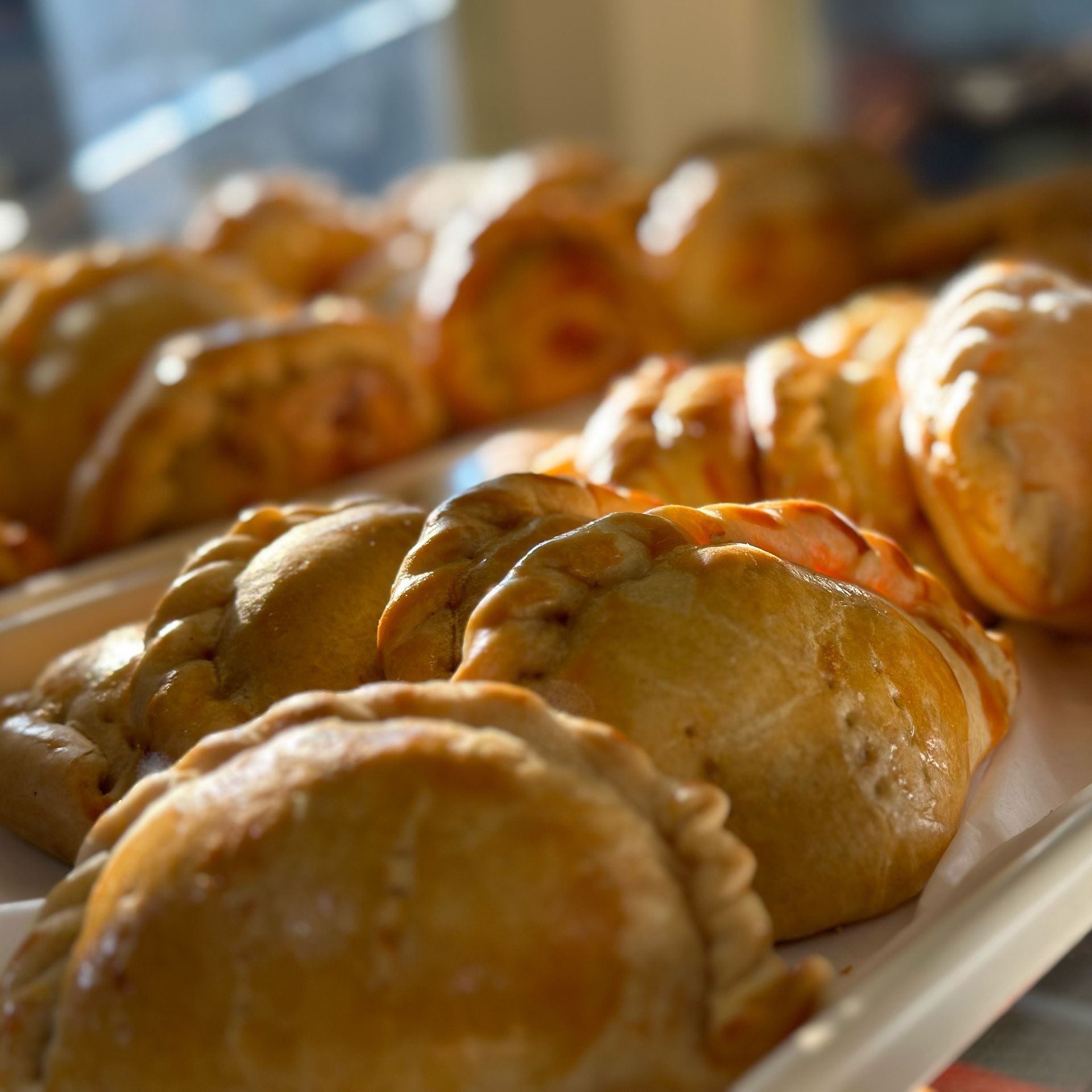 A bunch of pastries are on a tray on a table