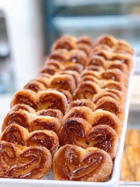 A tray of heart shaped pastries on a table
