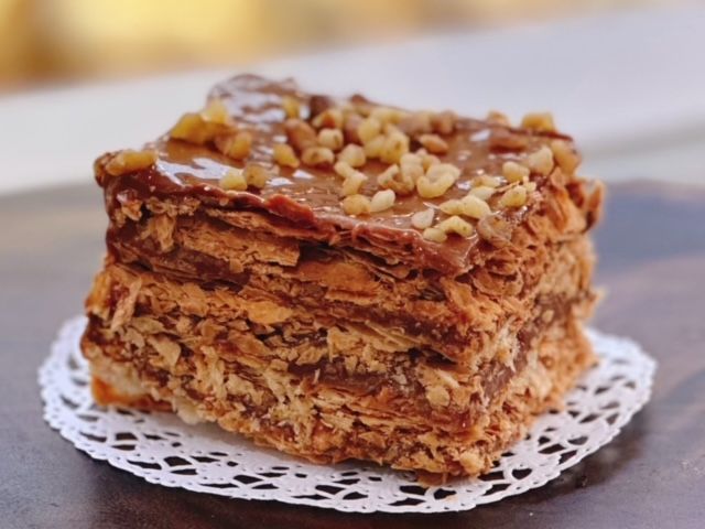 A piece of cake on a napkin on a table