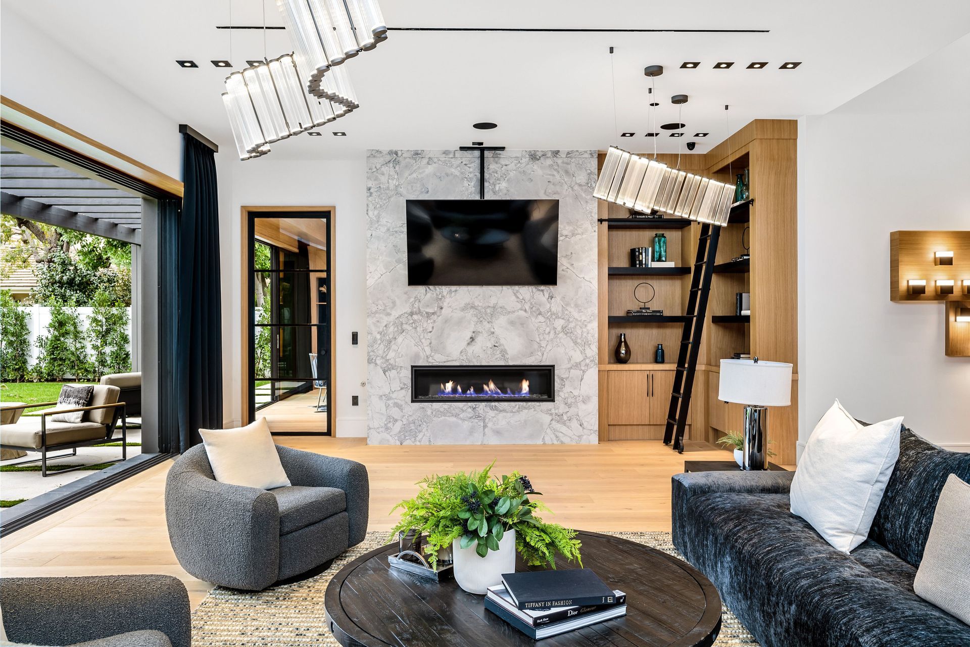 A living room with a fireplace and a potted plant.