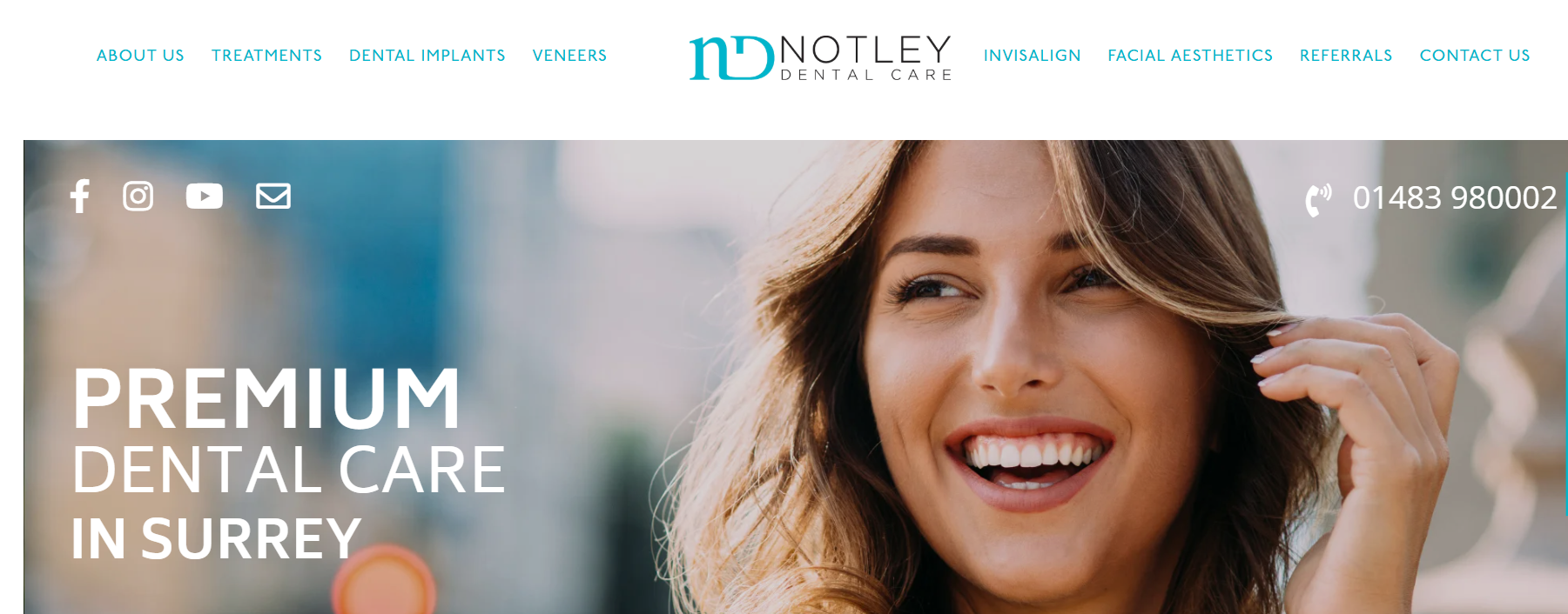 A woman is smiling on the homepage of a dental care website.