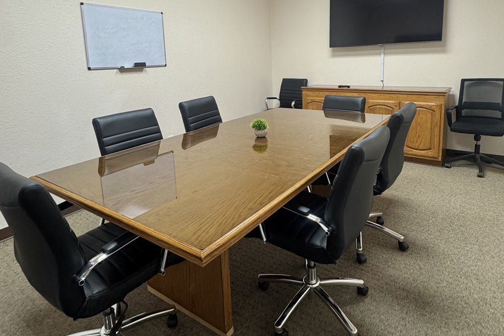 A conference room with a long table and chairs
