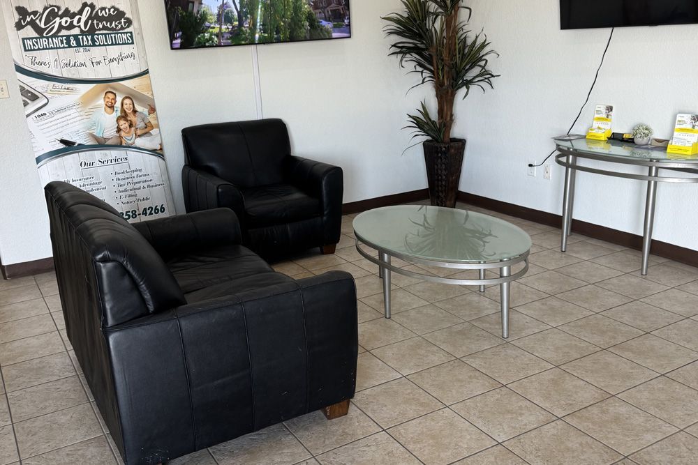 A living room with a couch , chairs , a table and a television.