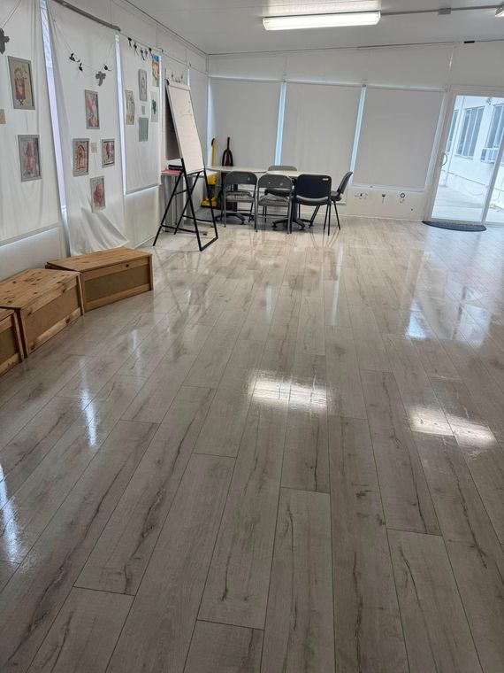 A large room with a table and chairs in it