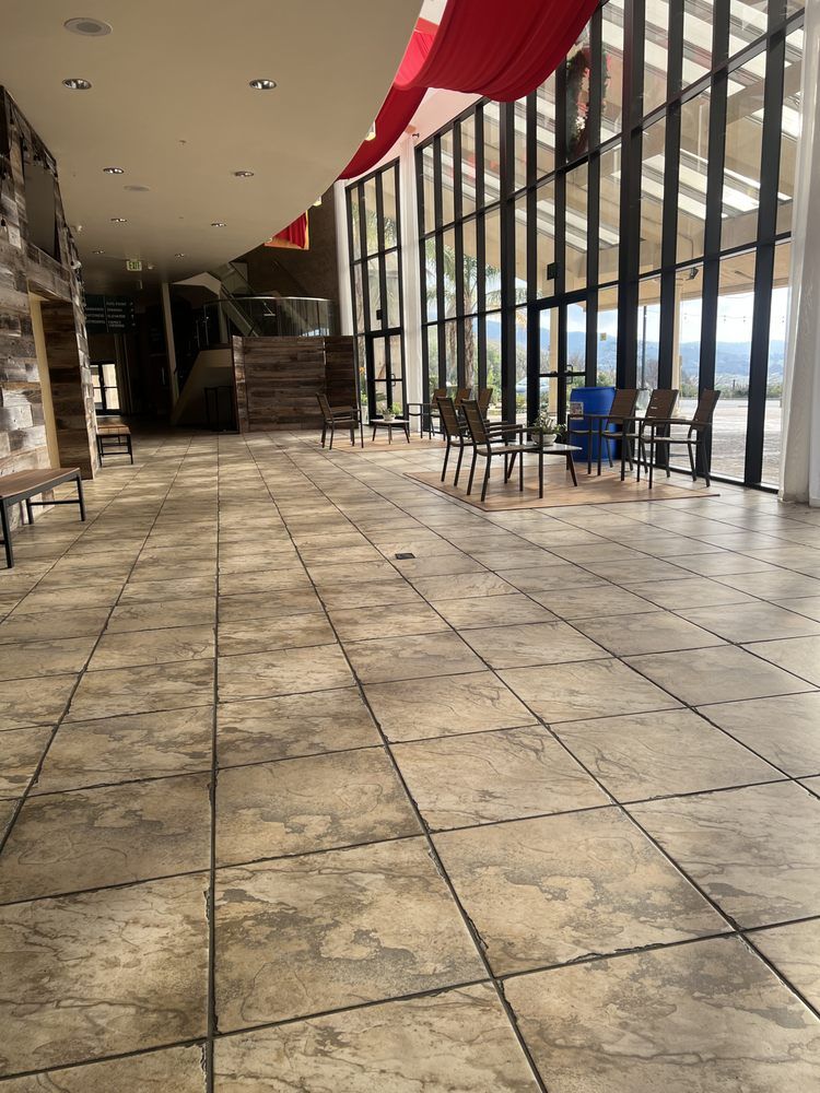 A large room with a tiled floor and a lot of windows.