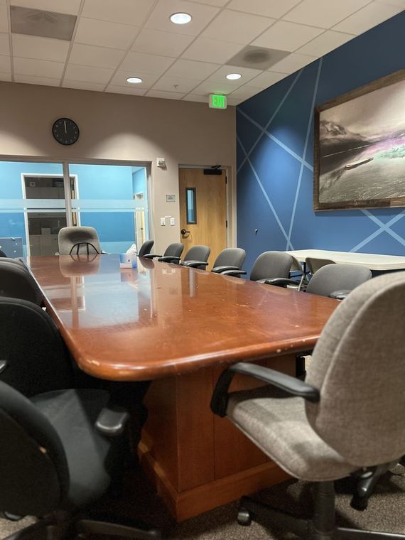 A conference room with a long table and chairs