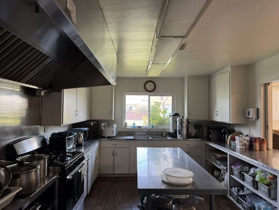 A kitchen with stainless steel appliances and white cabinets