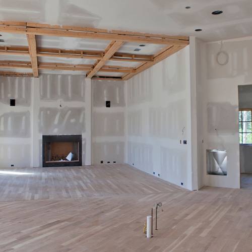 An empty room with a fireplace in the middle