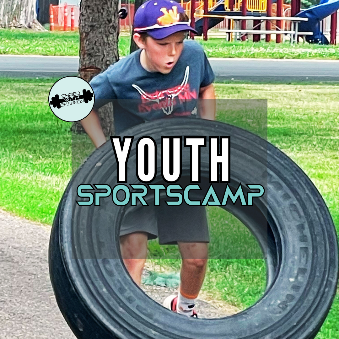 a young boy is playing with a tire in a park .