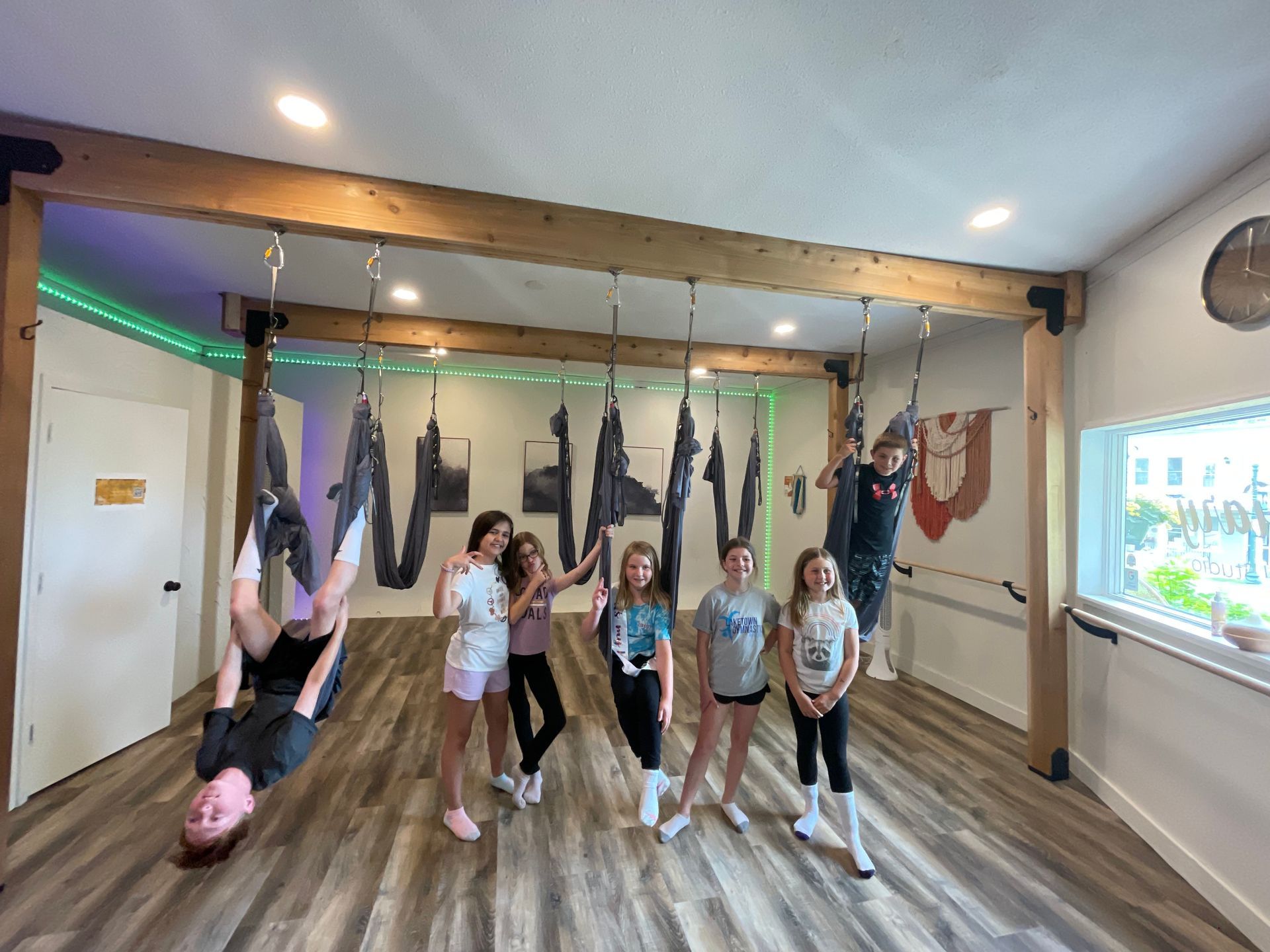 A group of children are posing for a picture in a gym.