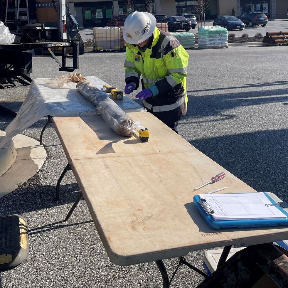 Prepared soil core samples laid out for review alongside field notebook during environmental site assessment.
