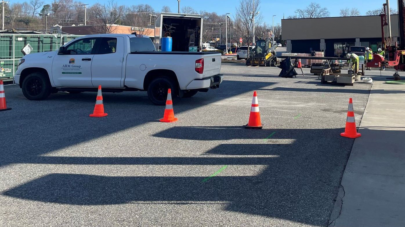 Field equipment and safety perimeter set up in gas station parking lot for vapor intrusion mitigation work.