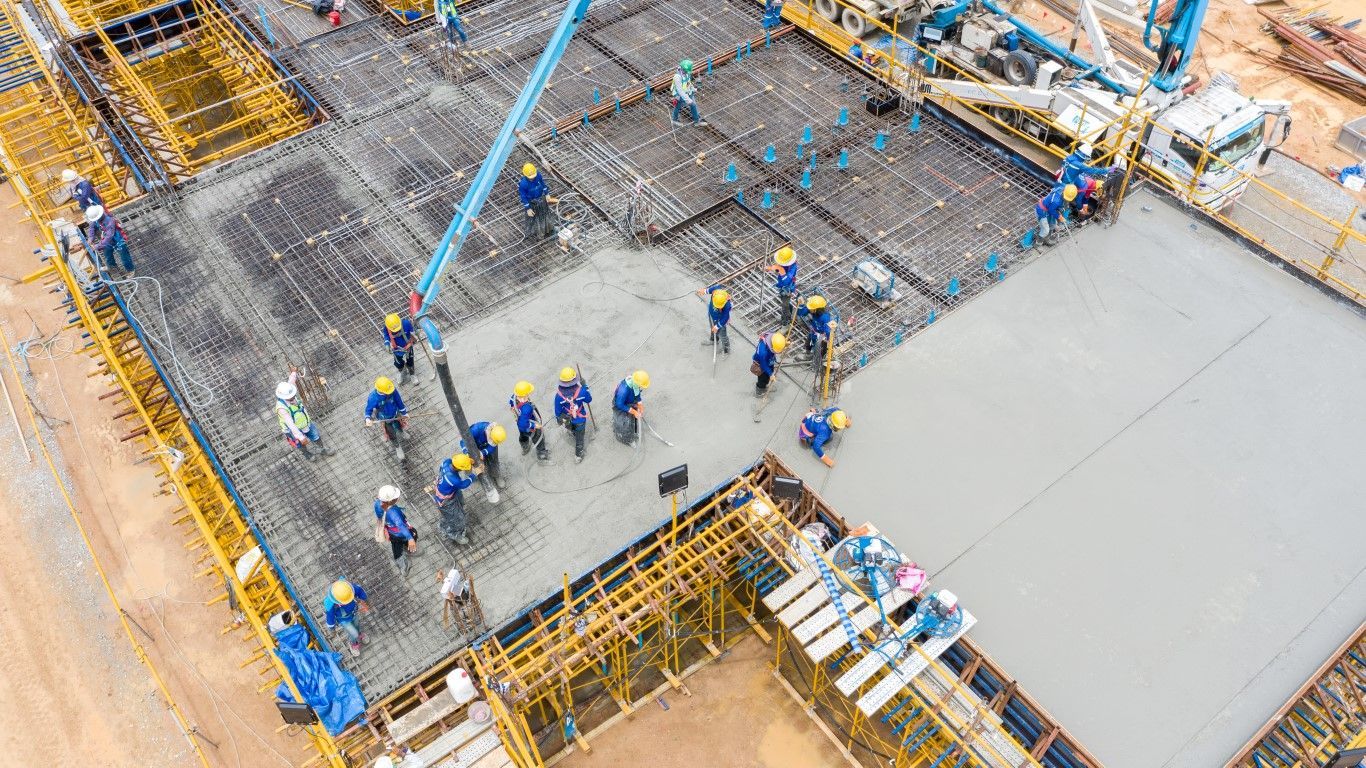 overhead photo of a construction worker operating a concrete pump