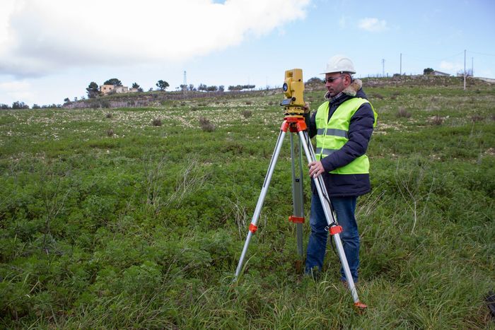 Engineer making a formal survey of the boundaries of a property