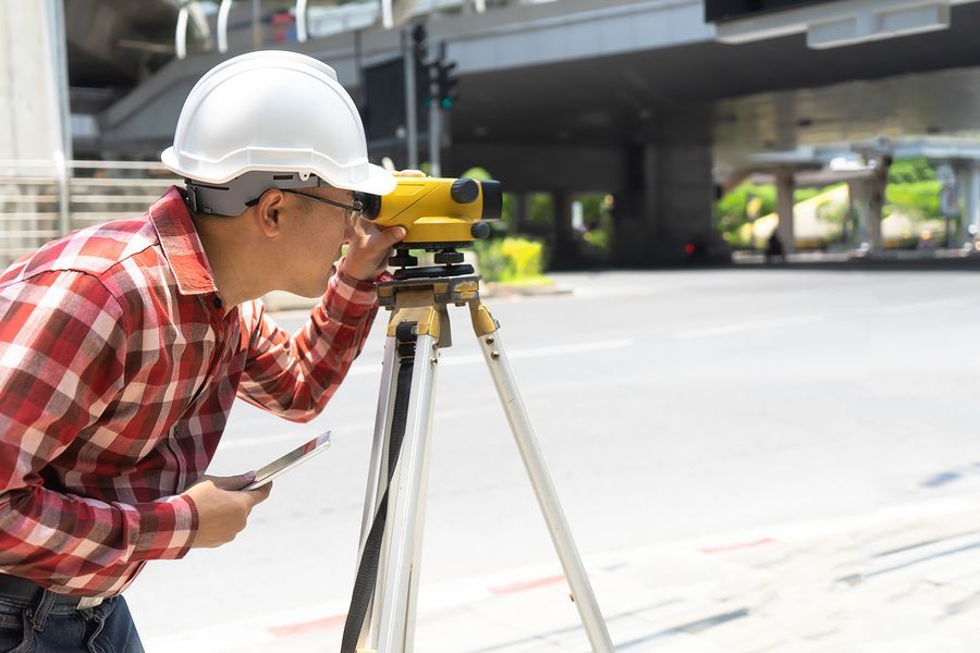 employee using an auto level instrument for land surveying in Jefferson