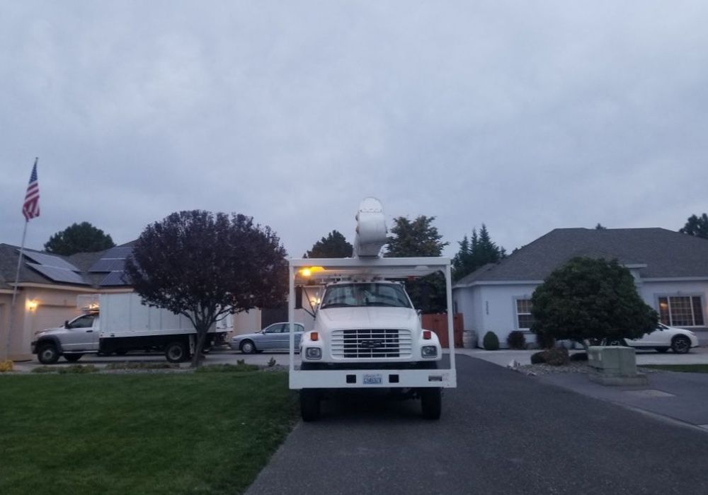 A white truck is parked in front of a house.