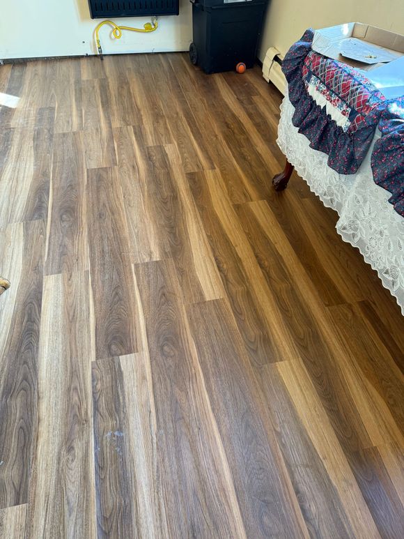Empty room with fresh geometric tile floor, wall outlets, and a small open utility cutout.