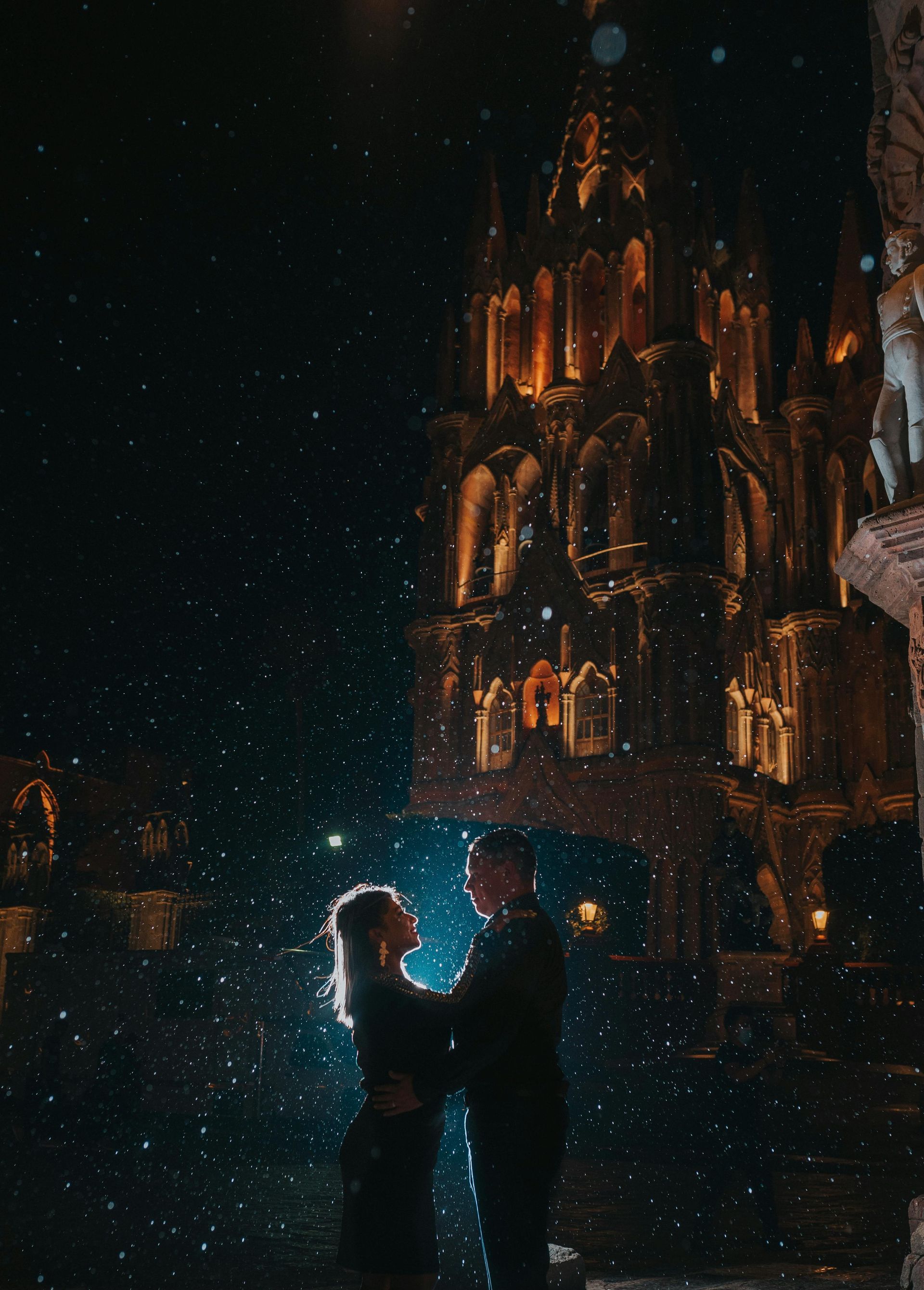Holidays to Mexico - A man and woman are dancing in front of a building at night in San Miguel de Allende