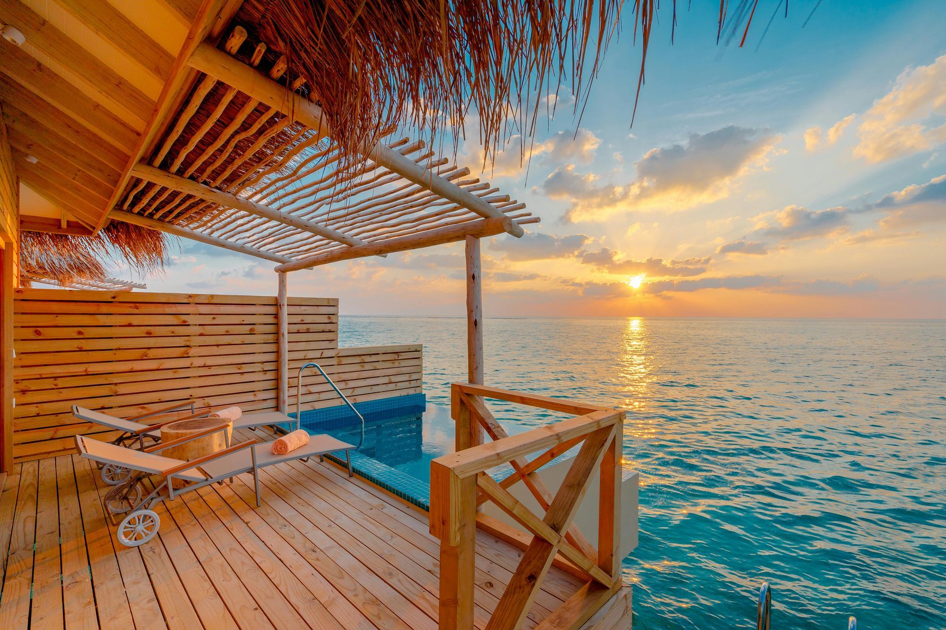 Maldives overwater villa surrounded by crystal-clear ocean