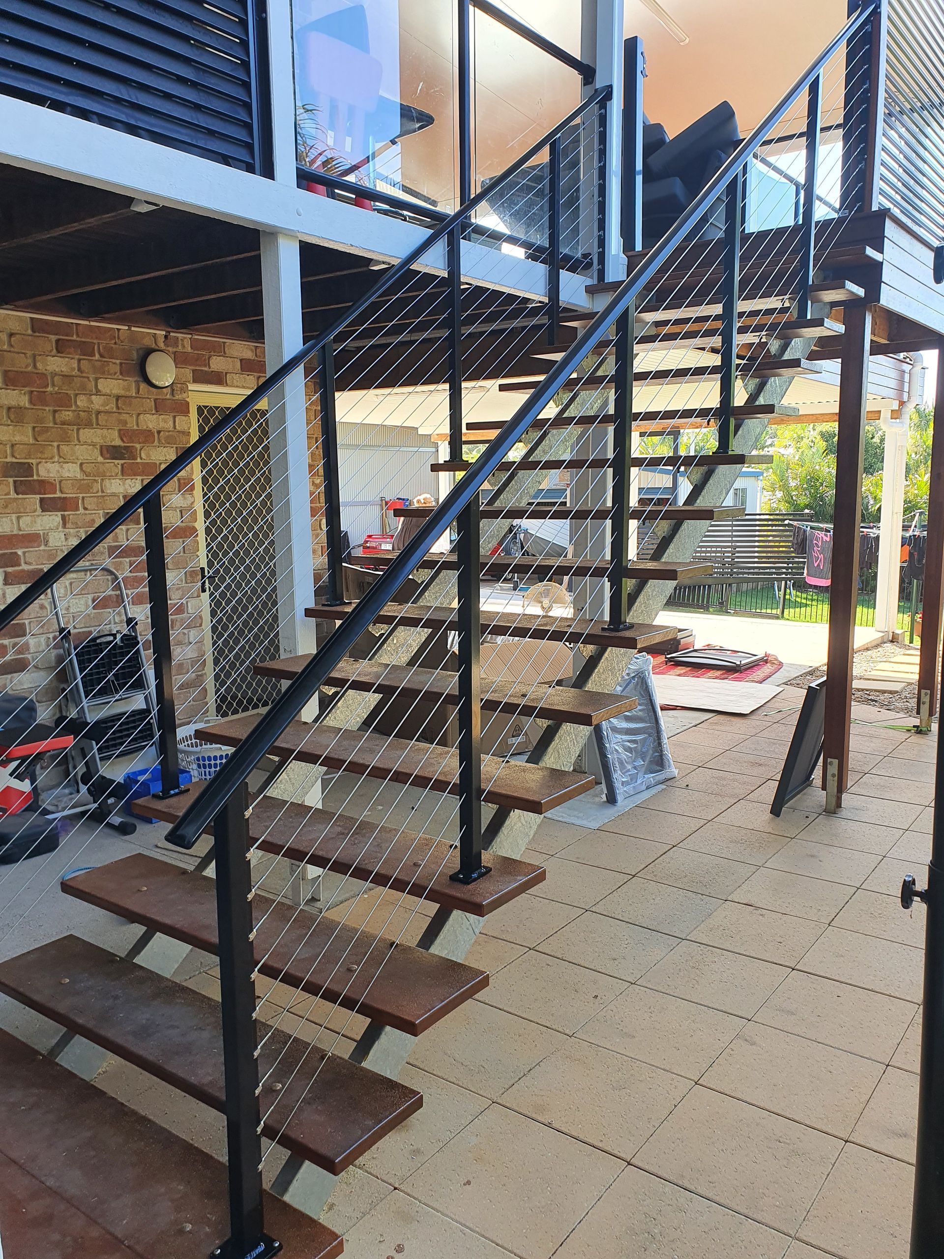 Outdoor Staircase With Dark Metal — Litzow’s Welding & Fabrication in Dundowran, QLD