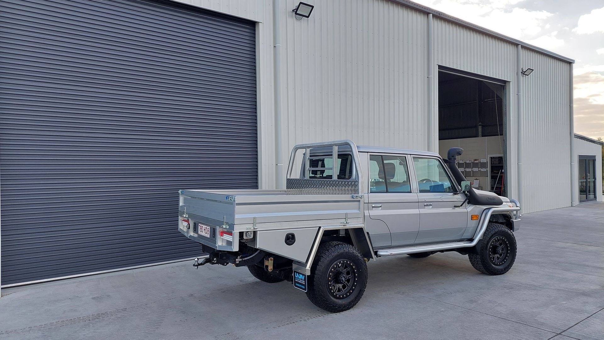 Silver Pickup Truck Parked Near a Gray Metal Building — Litzow’s Welding & Fabrication in Dundowran, QLD