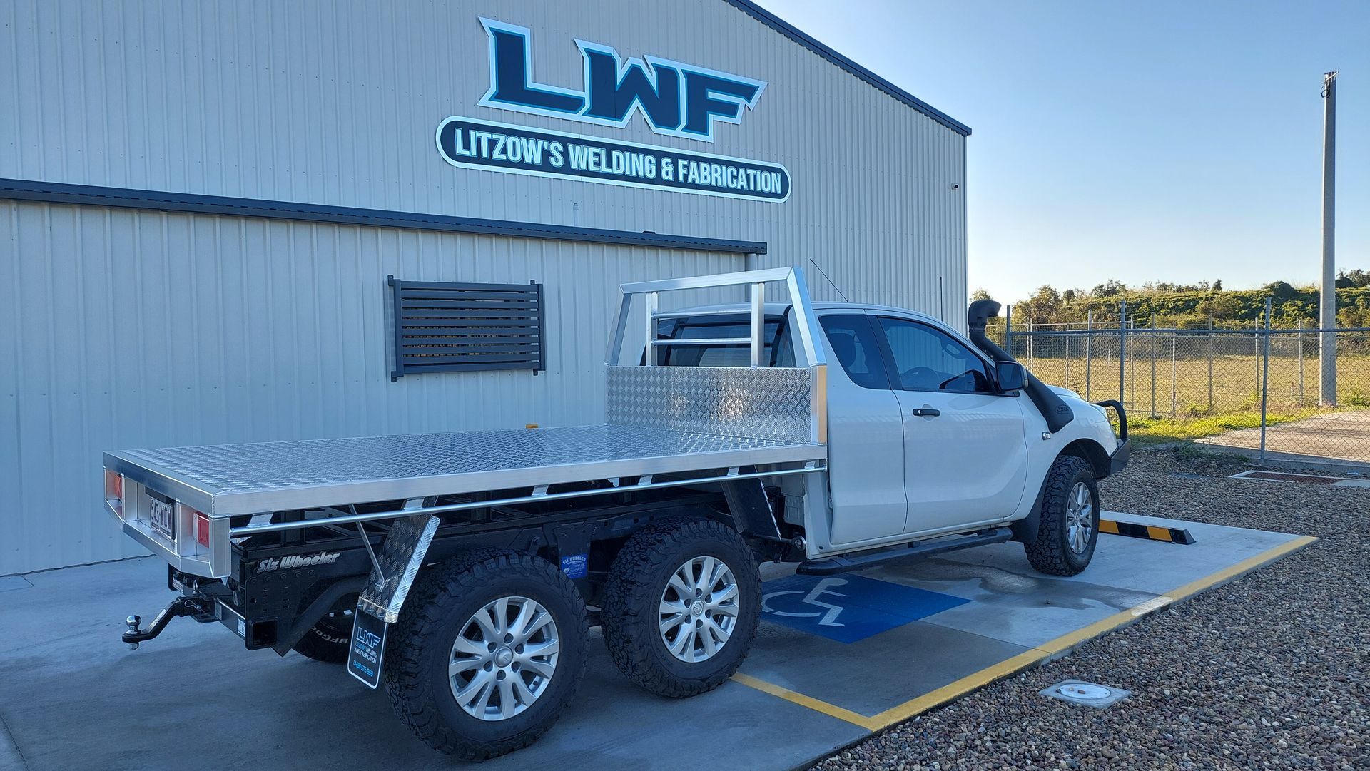 White Flatbed Truck With 6 Wheels — Litzow’s Welding & Fabrication in Dundowran, QLD