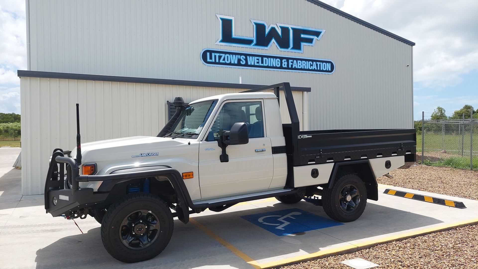 White Pickup Truck Parked in Front of a Building — Litzow’s Welding & Fabrication in Dundowran, QLD