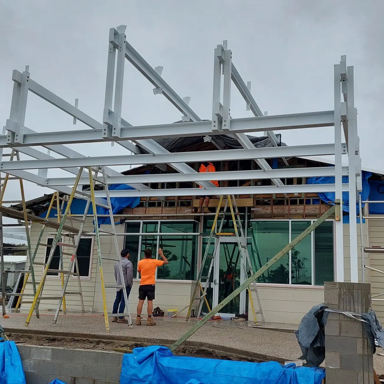 Construction Site With Workers Assembling Steel Framework — Litzow’s Welding & Fabrication in Dundowran, QLD