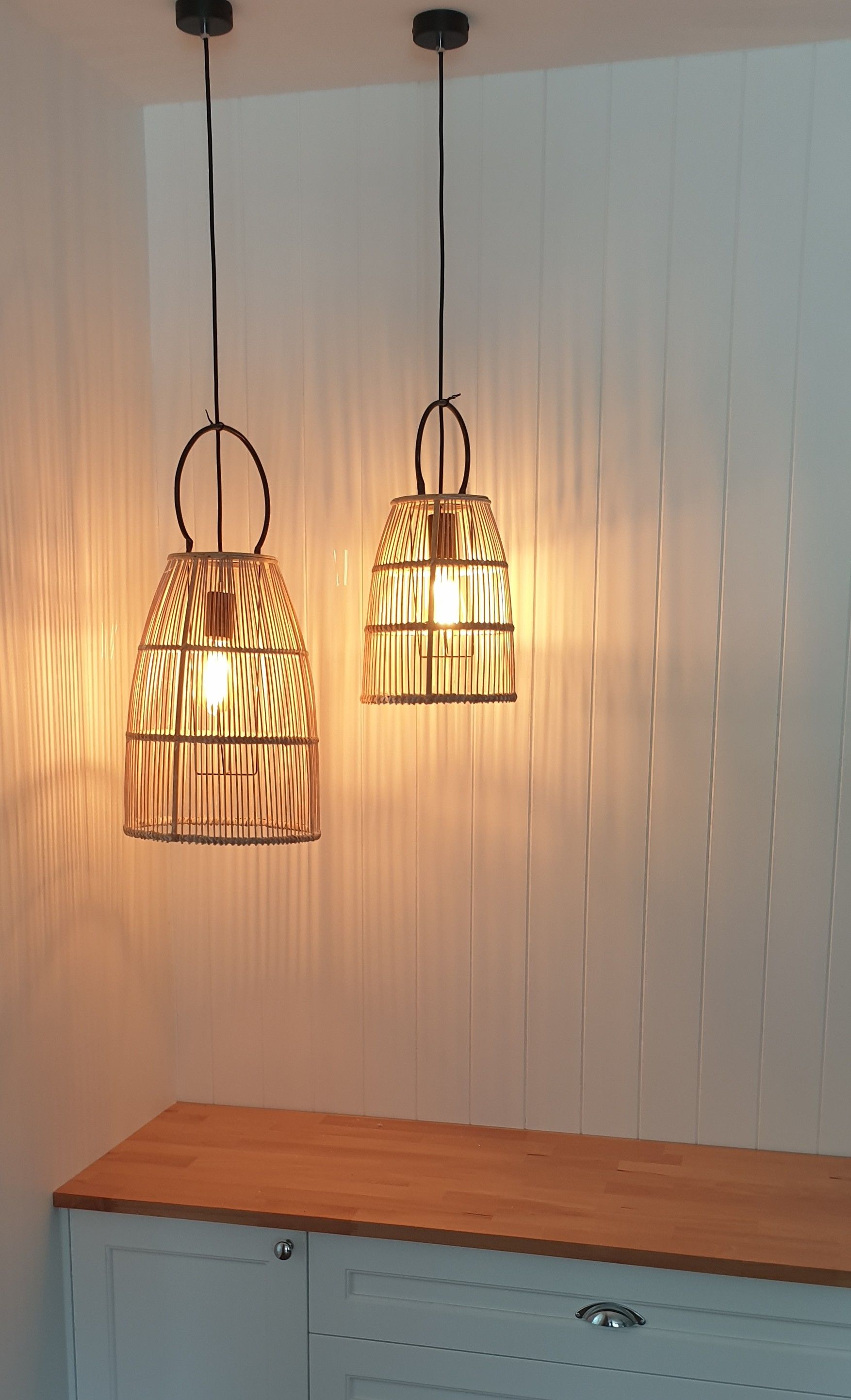 A Person is Installing a Light Fixture on a Ceiling — Riselectrical In Tweed, NSW