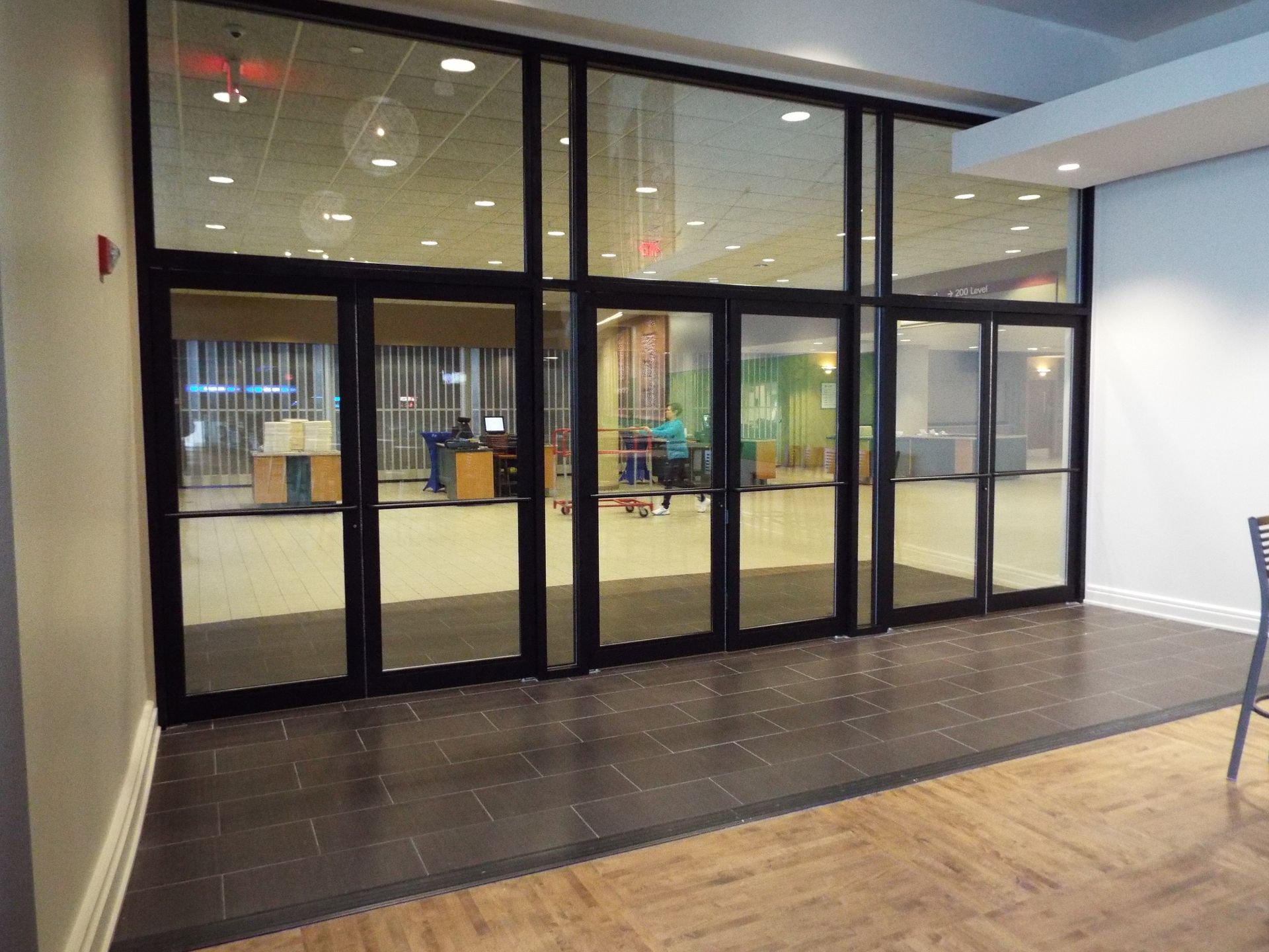 A building with a lot of glass doors and a wooden floor