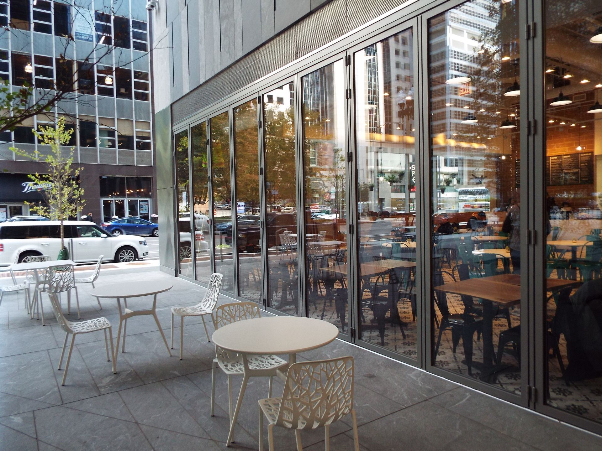 A patio with tables and chairs outside of a building