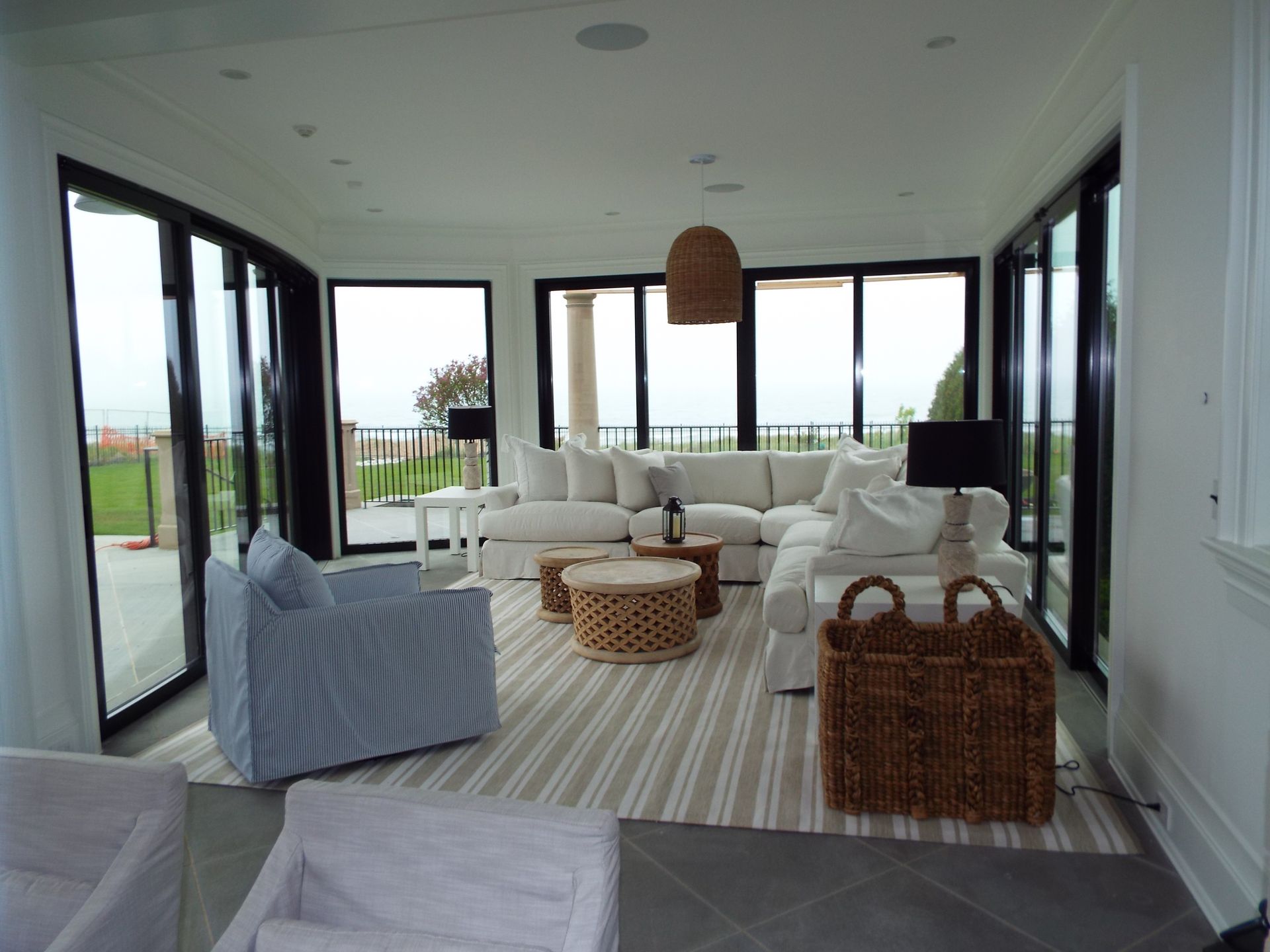 A living room with a large sectional couch and chairs