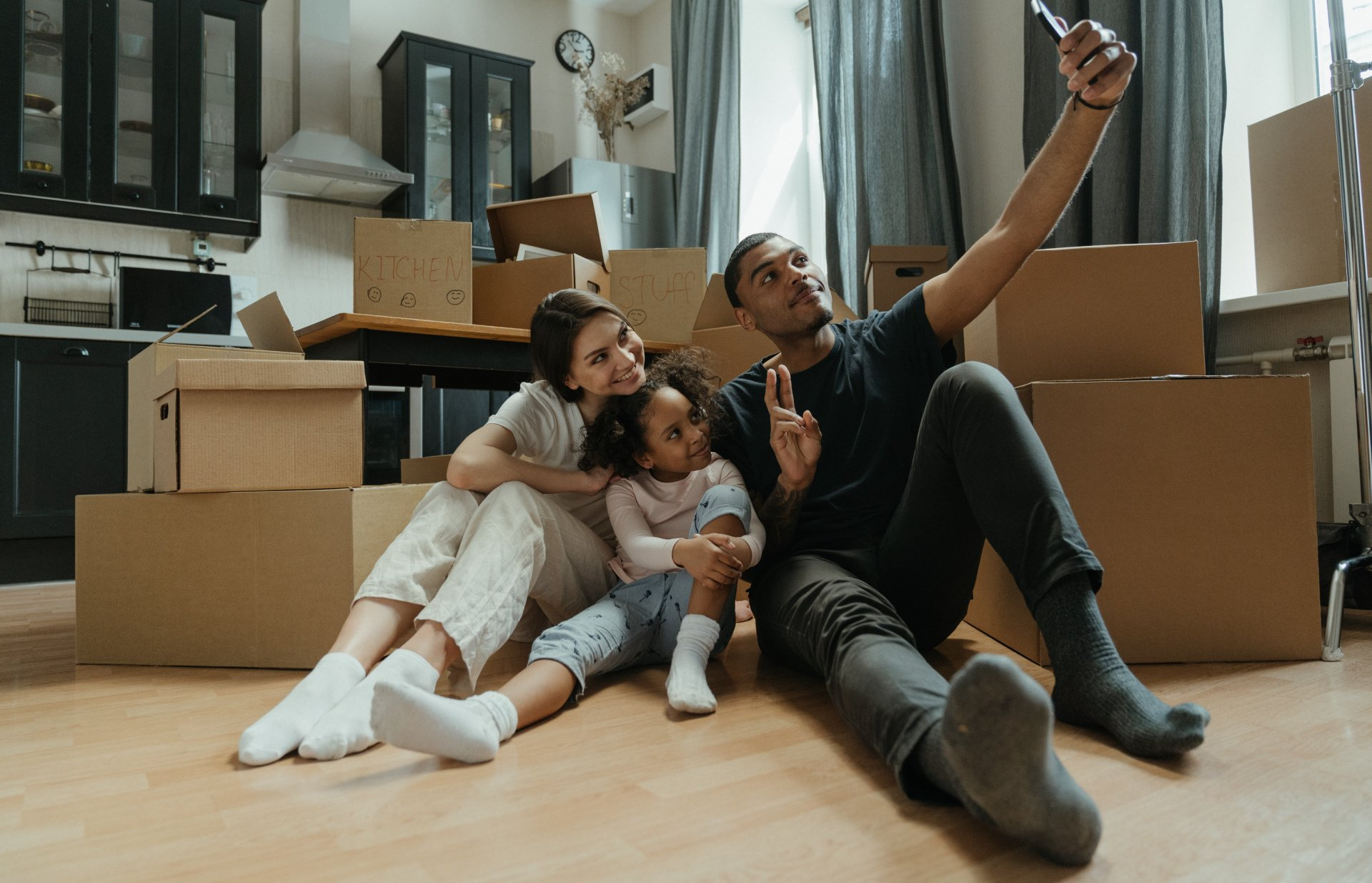 A man wearing a hard hat and safety vest is holding a level