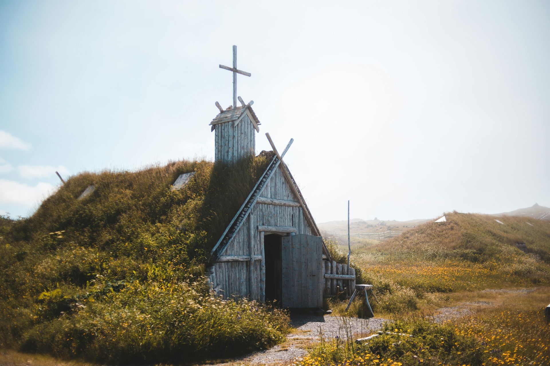A small church with a cross on top of it.