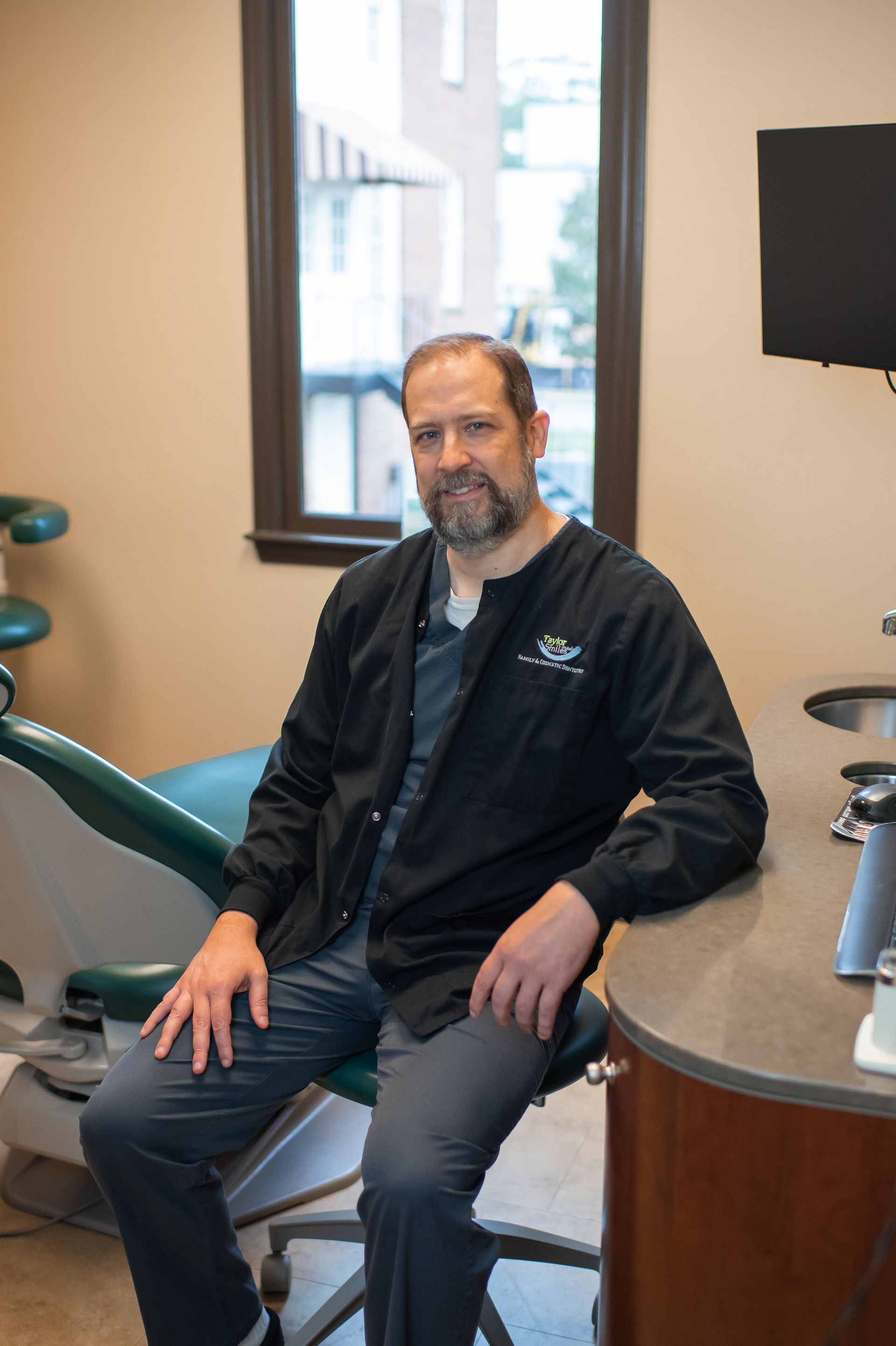 A woman is getting her teeth examined by two dentists