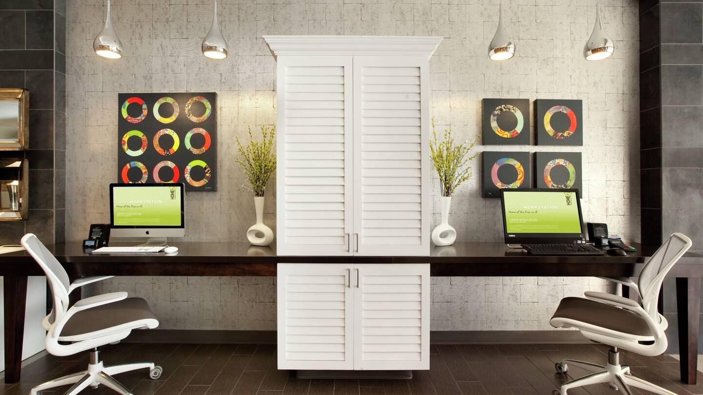 A home office with two desks and two chairs