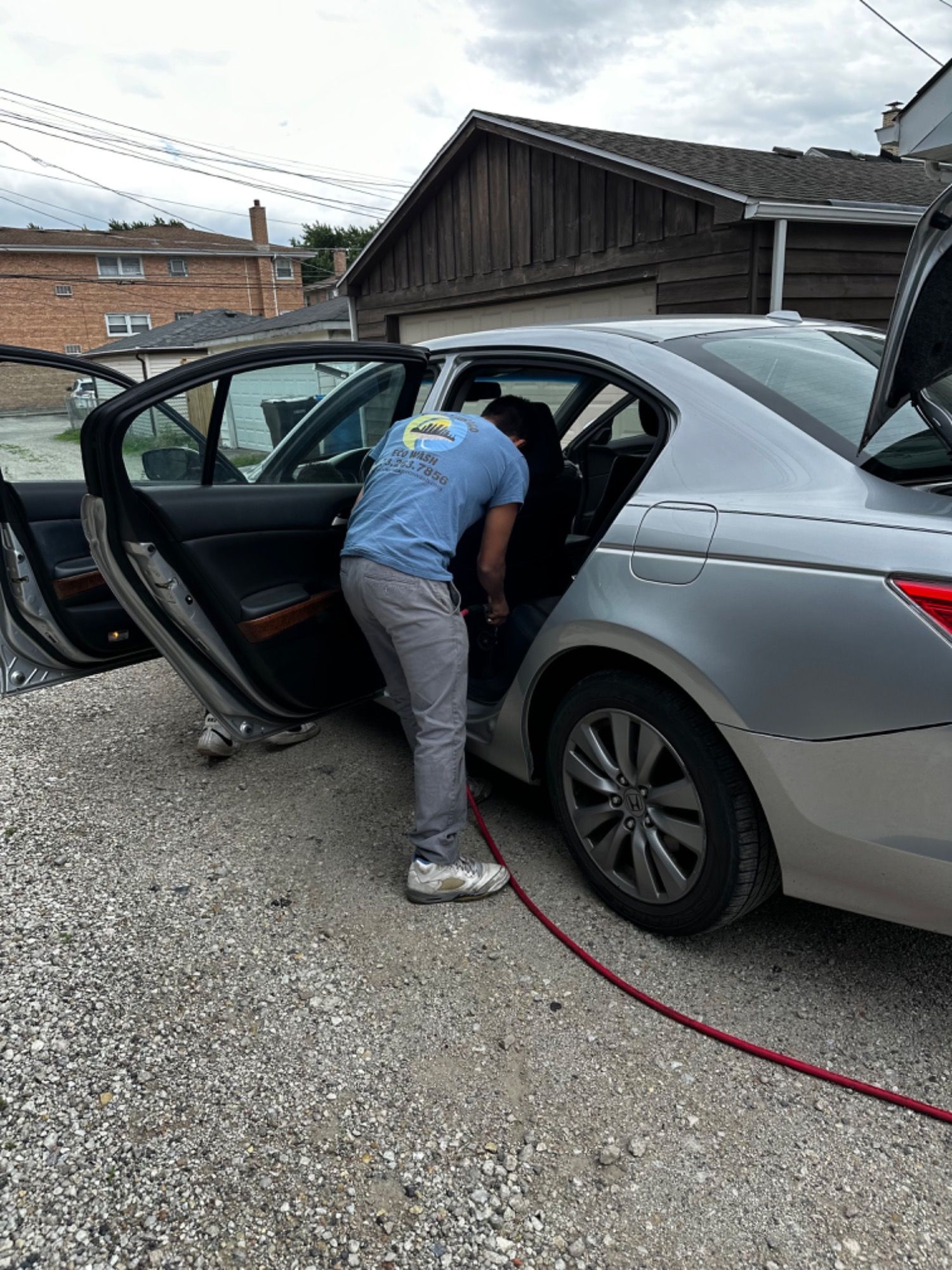 A man is getting into the back seat of a car.