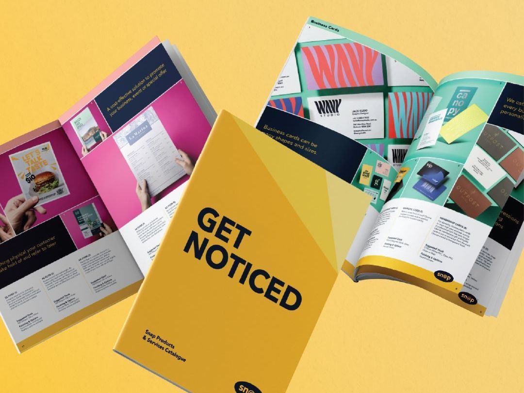 A yellow book that says get noticed on it