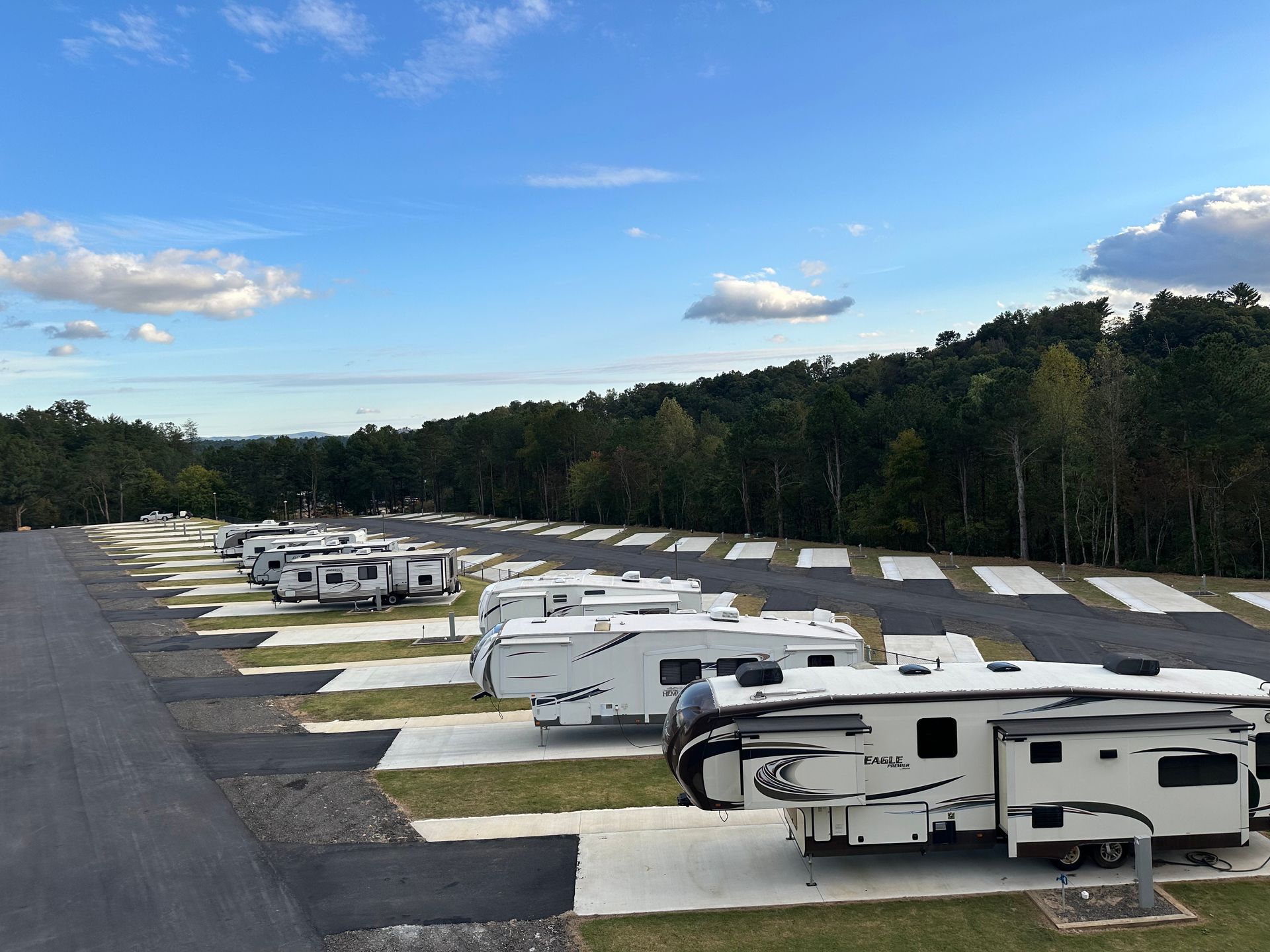 An aerial view of a city surrounded by trees and buildings on a sunny day.