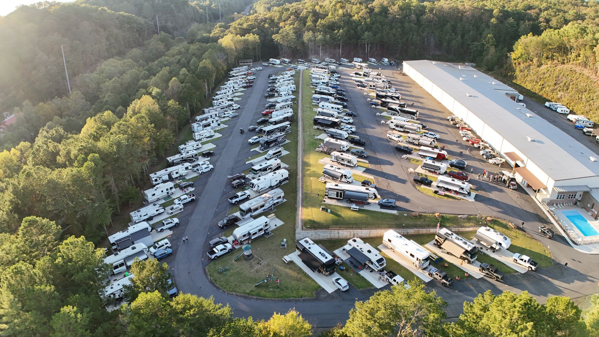 A large body of water with mountains in the background at sunset.